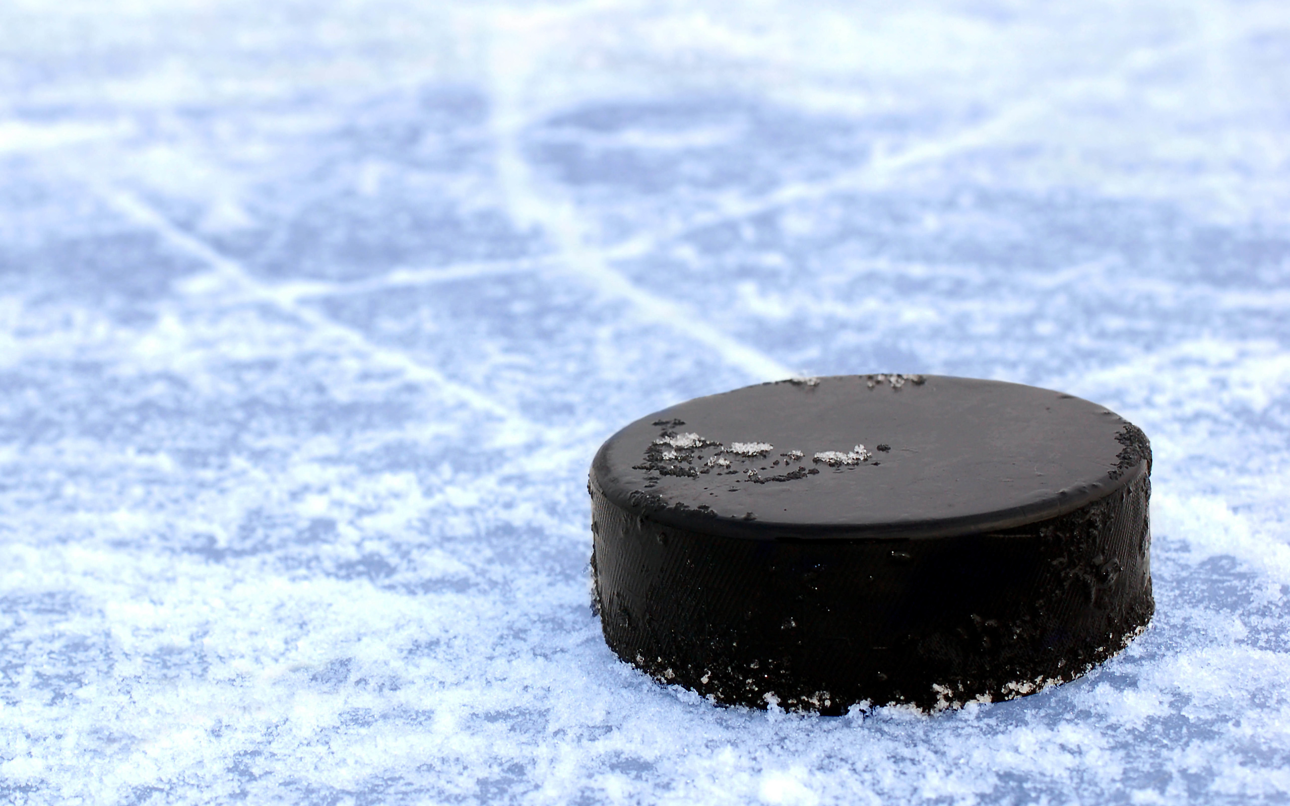 hockey puck sitting on ice standard equipment for hockey hockey puck