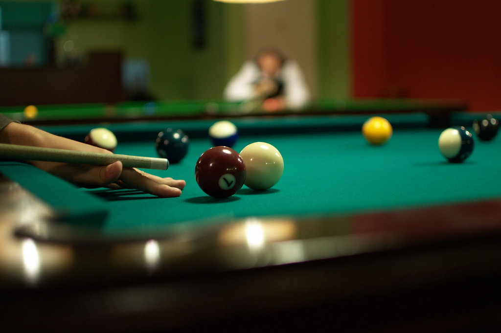 player setting up a shot billiards/pool standard equipment billiard balls