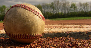 dirty baseball laying in the dirt in the diamond standard equipment for baseball is the ball