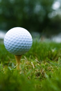 golf ball sits on tee on the grass standard golf equipment golf ball and standard tee