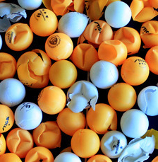mixture of white and orange table tennis balls some are smashed and some are not basic equipment for table tennis ping ping balls