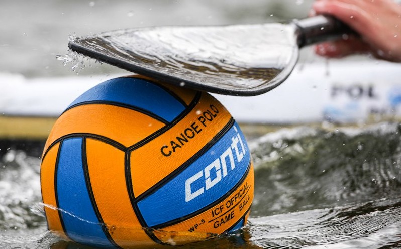 blue and orange canoe polo ball with paddle above basic equipment for canoe polo regulated ball