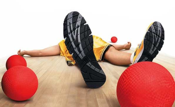 ad from dodgeball movie man laying on ground with view from under the soles of tennis shoes 4 red dodgeball balls basic equipment of dodgeball 4 red blocker balls 2 red stinger balls