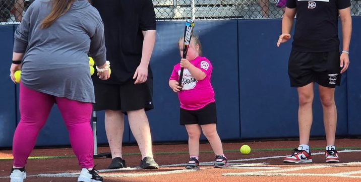 Young lady at bat during a Challenger Baseball game